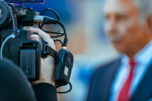 Cameraman recording at media press conference. Live streaming concept.